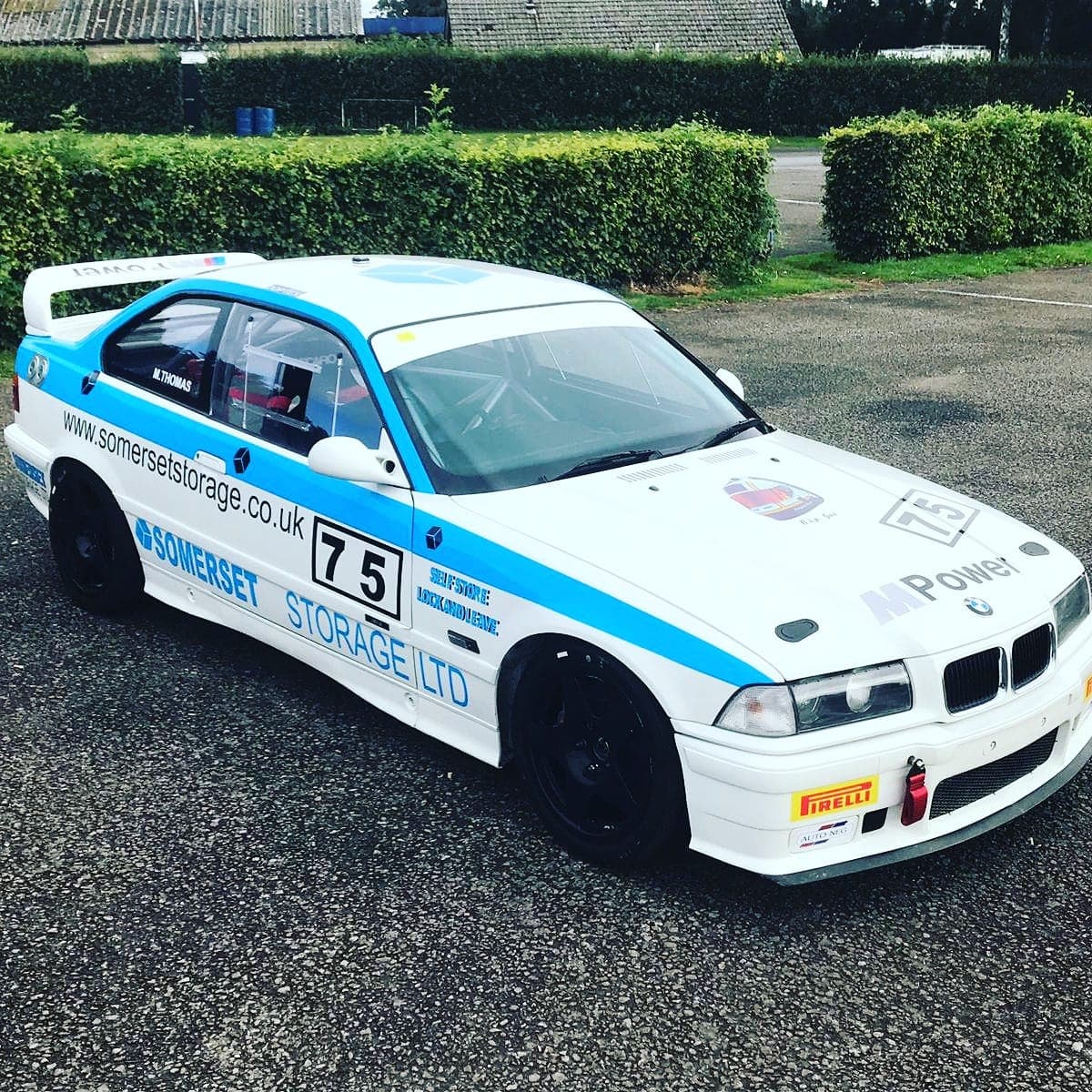 A white and blue BMW E36 race car