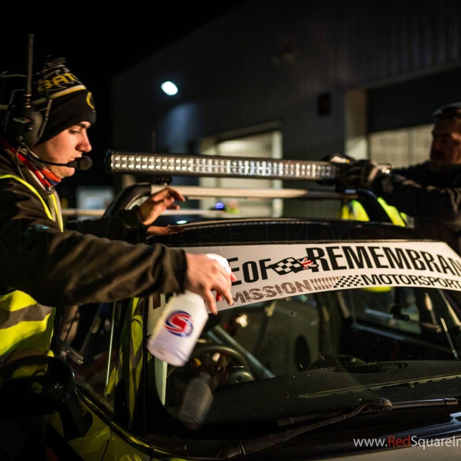 A TTR Motorsport crew member at the race car at night