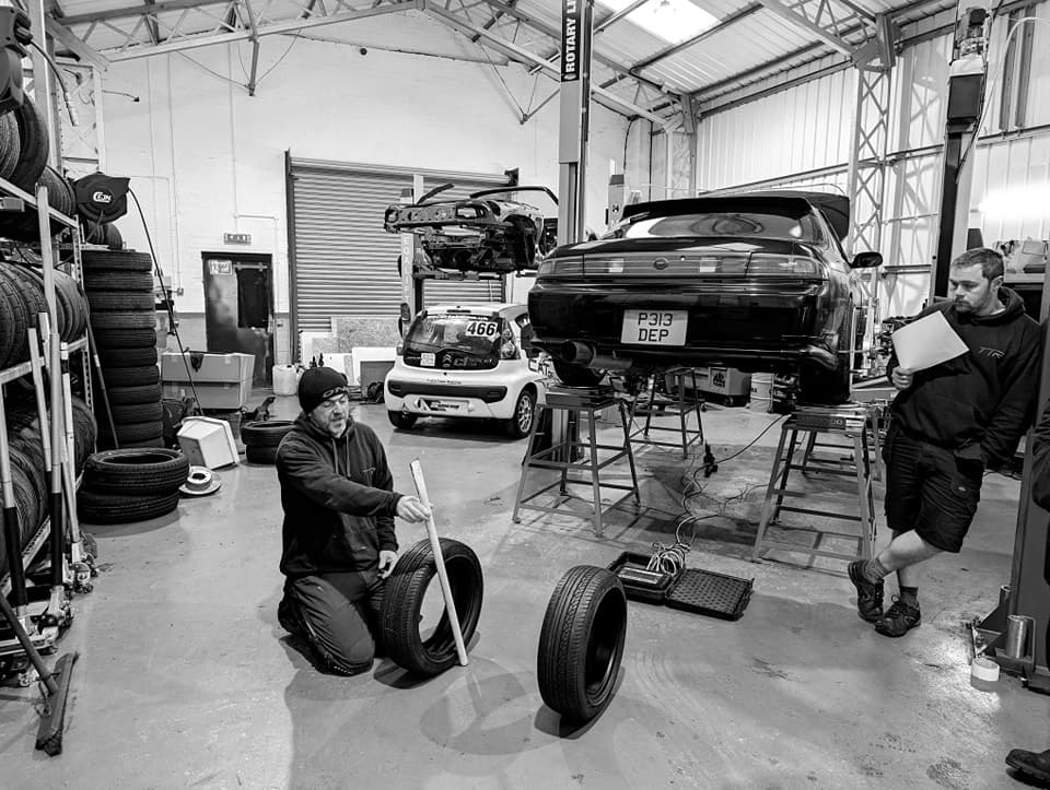 A workshop crew working on track cars